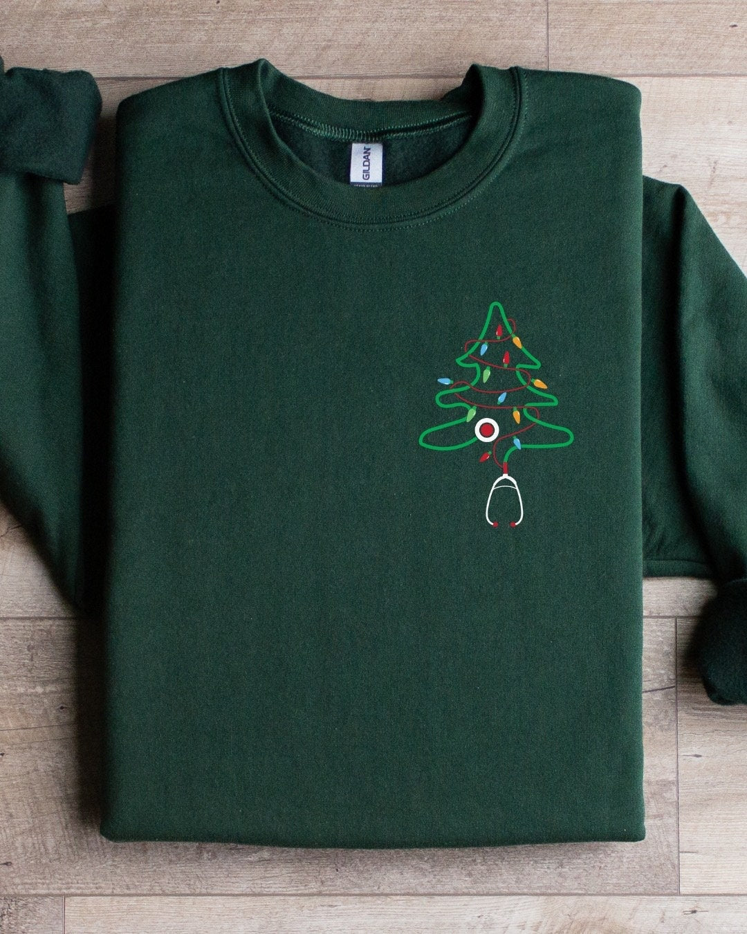 Nurse Christmas Sweatshirt with Christmas tree stethoscope design.