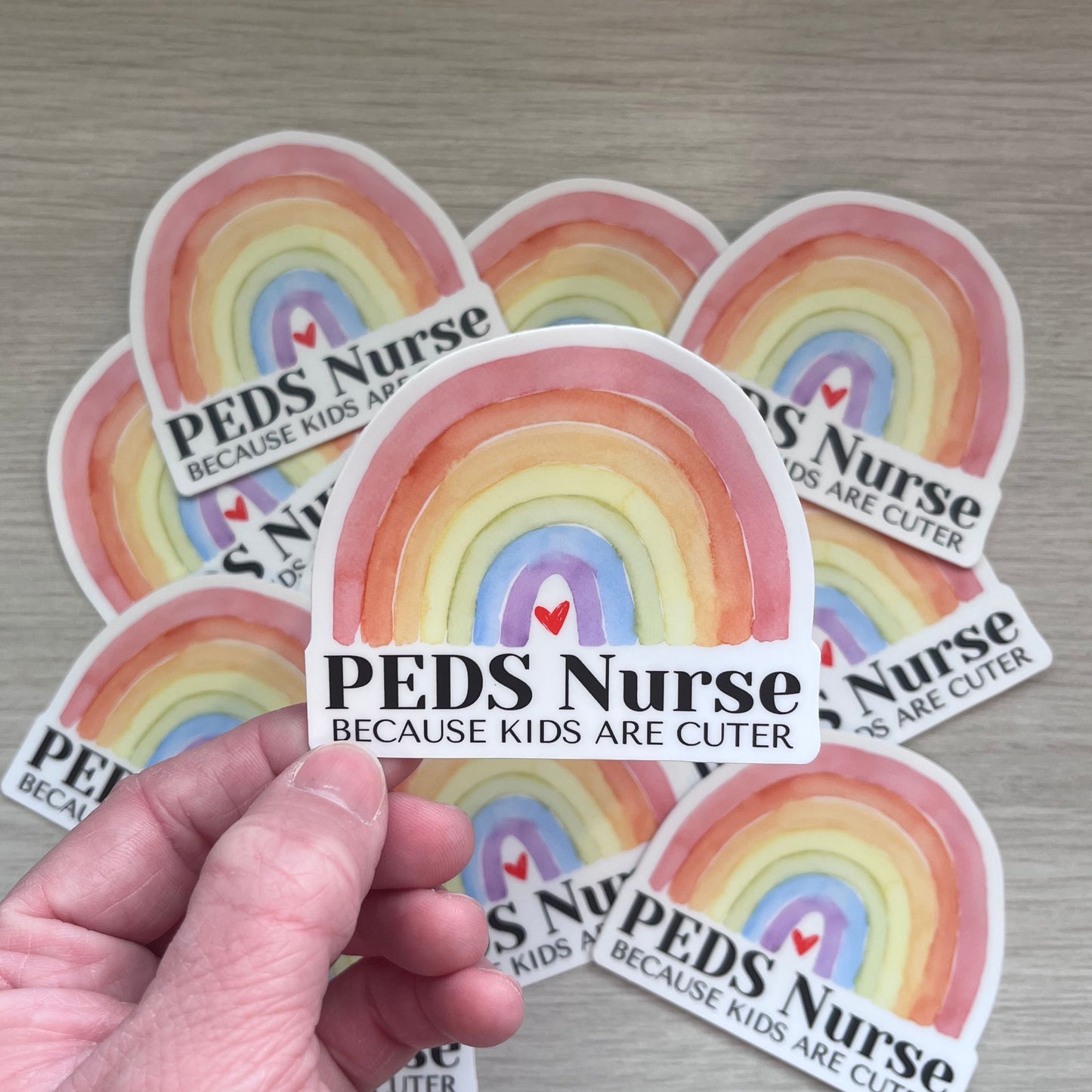 Funny Pediatric Nurse Rainbow Water bottle sticker with phrase "Peds Nurse Because Kids Are Cuter."